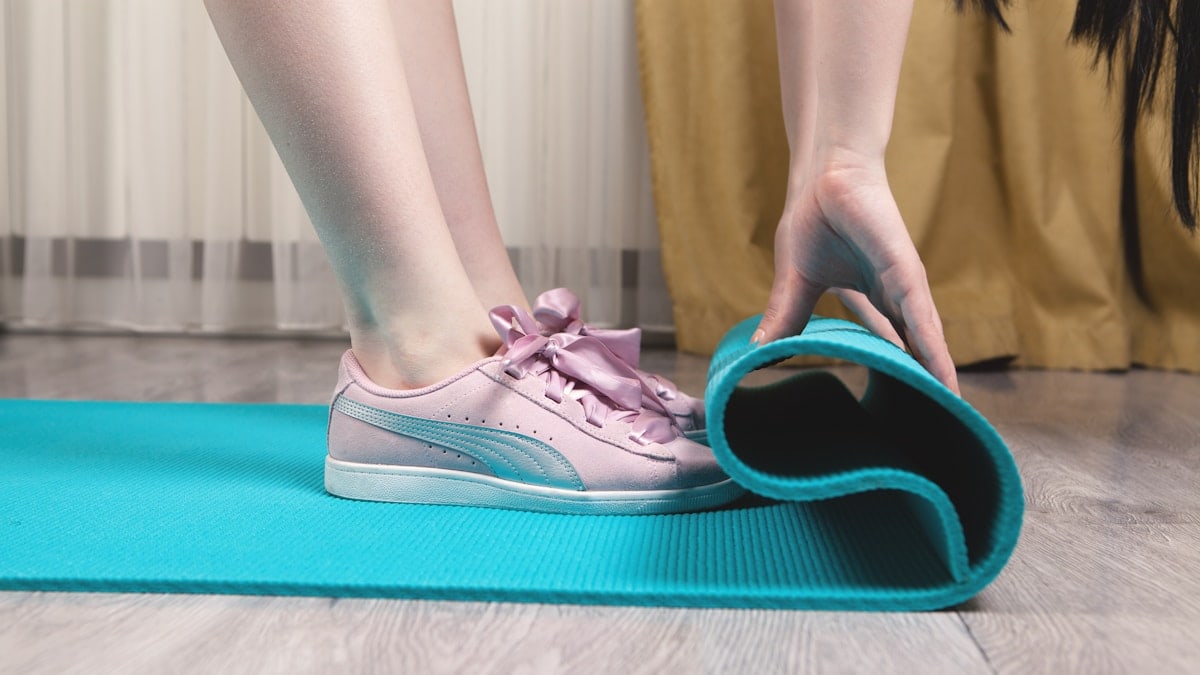 person wearing teal and white nike sneakers